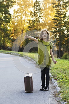 Traveler girl with a suitcase