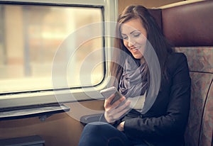 Traveler girl use the phone on train