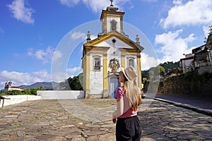 Traveler girl visiting the historic city of Ouro Preto, UNESCO world heritage site in Minas Gerais state, Brazil photo
