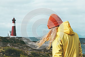 Traveler girl walking at Norway lighthouse sea landscape Travel Lifestyle concept adventure