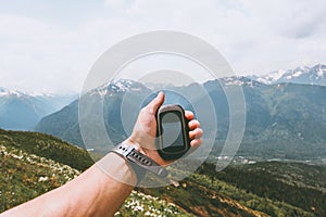 Traveler hand holding gps navigator tracker looking for location coordinates