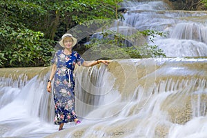 Traveler happy in waterfall  at Erawan Waterfall and  natural