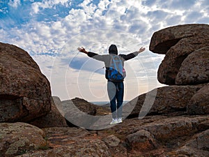 Traveler hiker man with backpack raised hands mountain summit. Active Lifestyle tourism Solo Travel Scenic hiking trail