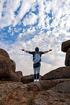 Traveler hiker man with backpack raised hands mountain summit. Active Lifestyle tourism Solo Travel Scenic hiking trail