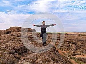 Traveler hiker woman with backpack raised hands on mountain summit Girl backpacker enjoying scenic landscape aerial view