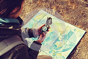 Traveler holding a compass in the forest