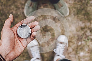 Traveler holding compass in hand