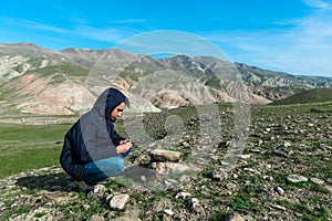 Traveler holding a compass in mountains
