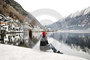 Traveler-Image. Traveler look at the mountain lake in winter. Travel and active life concept. Adventure and travel in