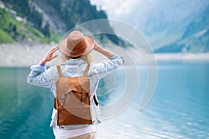 Traveler-Image. Traveler look at the mountain lake. Travel and active life concept.