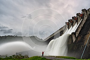 Traveler with a large dam gate. Dam with floodgate