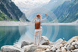 Traveler look at the mountain lake. Travel and active life concept.