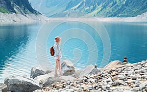Traveler look at the mountain lake. Travel and active life concept. Adventure and travel