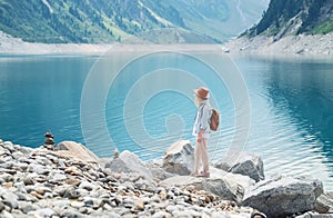 Traveler look at the mountain lake. Travel and active life concept. Adventure and travel in the mountains region in the Austria.