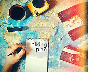 Traveler makes a trip hiking plan. camping gear, top view