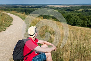 Traveler male relaxing meditation with serene view mountains landscape summer day.Relaxing middle age man in nature