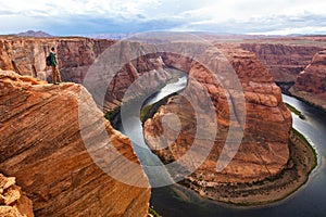Traveler man on the background of the canyon Horseshoe bend, Arizona, USA. Travel concept, scenic view