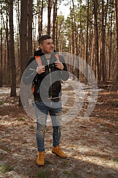 Traveler Man with backpack hiking Travel Lifestyle concept.  The traveler goes through the forest