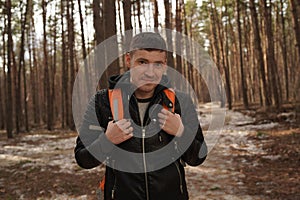 Traveler Man with backpack hiking Travel Lifestyle concept.  The traveler goes through the forest