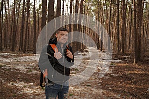 Traveler Man with backpack hiking Travel Lifestyle concept.  The traveler goes through the forest