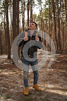 Traveler Man with backpack hiking Travel Lifestyle concept.  The traveler goes through the forest