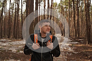 Traveler Man with backpack hiking Travel Lifestyle concept.  The traveler goes through the forest