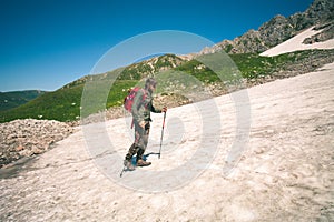 Traveler Man with backpack mountaineering glacier