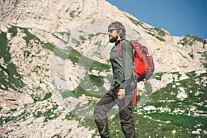 Traveler Man bearded with backpack mountaineering