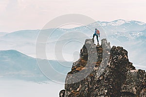 Traveler man climbing on mountain top adventure travel extreme