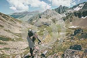 Traveler man climbing in mountains with backpack Travel Lifestyle hiking