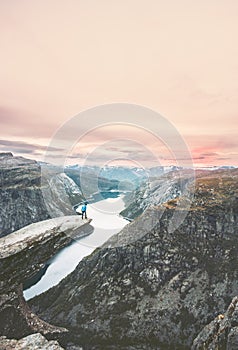 Traveler man on the edge of Trolltunga cliff