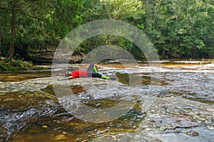 Traveler man enjoying in the Waterfall at Phu Kradueng national park, Loei Thailand, beautiful landscape of waterfalls in