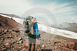 Traveler Man hiking in mountains with backpack