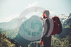 Traveler Man hiking in mountains with backpack