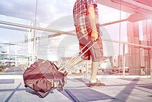 Traveler man at international airport moving to terminal gate