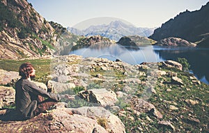 Traveler Man meditating yoga relaxing alone sitting lotus pose on stone