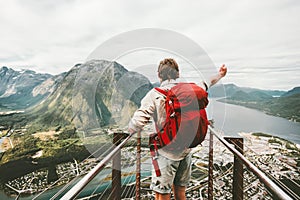 Traveler man raised hand showing mountains