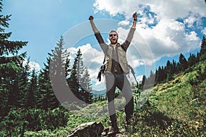 Traveler man standing on green mountain hill