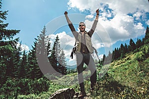 Traveler man standing on green mountain hill photo