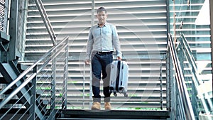 Traveler man with suit case walking on stair