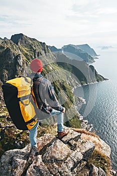 Professional expeditor standing on the edge cliff rock and looking forward away. Wanderlust