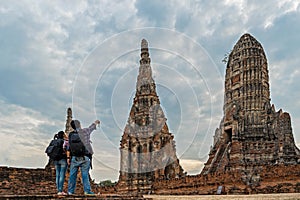 Traveler man and women with backpack walking in asia temple Ayuttaya, tourists travel in Thailand. photo