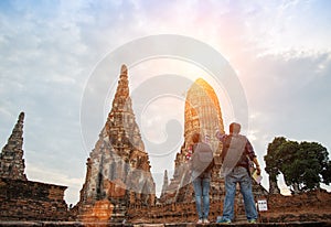 Traveler man and women with backpack walking in temple Ayuttaya ,