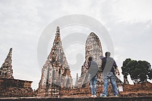 Traveler man and women with backpack walking in temple Ayuttaya photo