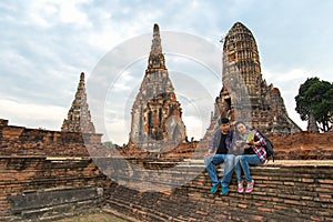 Traveler man and women with backpack walking in temple Ayuttaya ,Thailand