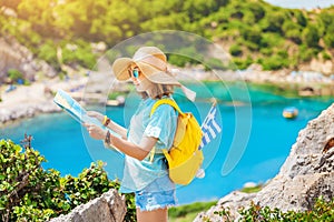 Traveler with map looking for interesting places near the blue lagoon bay on the Greek island of Rhodes