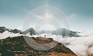 Traveler in mountains clouds landscape