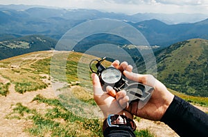 A traveler in the mountains with a compass