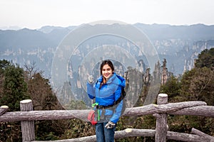 Traveler post for picture took at Zhangjiajie national park, Hunan province, China.