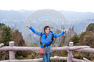Traveler post for picture took at Zhangjiajie national park, Hunan province, China.